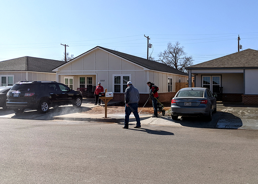 Mandry employees and their families helping power wash for Lubbock Habitat for Humanity