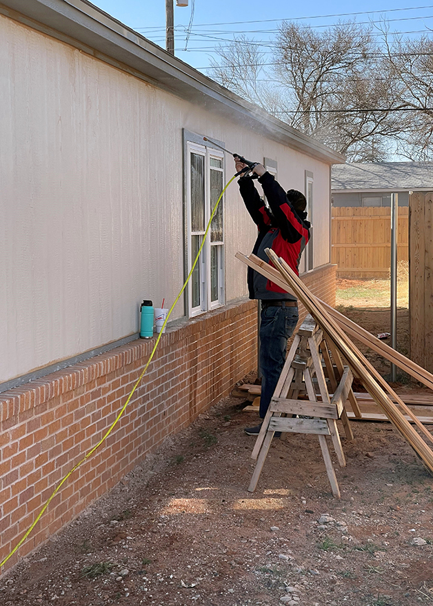 Mandry employees helping power wash houses for Lubbock Habitat for Humanity